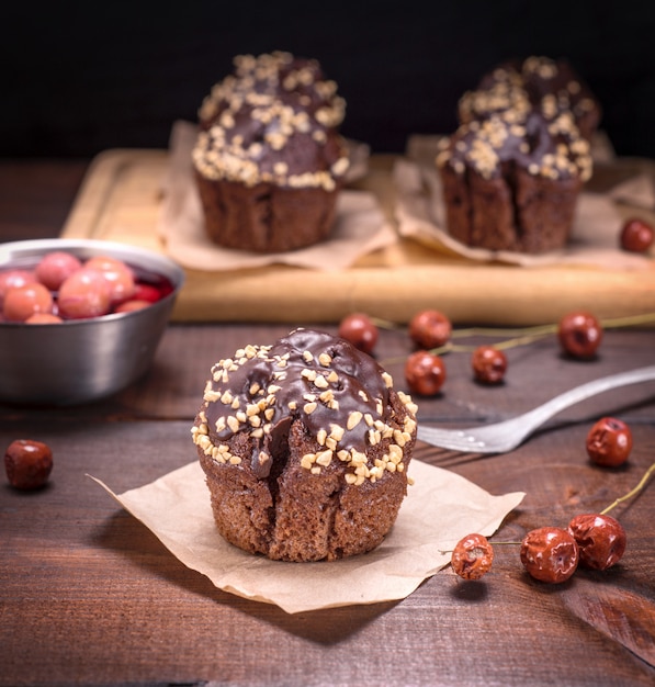 Chocolate cupcakes are sprinkled with ground nut 