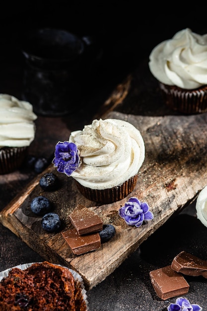 Chocolate cupcakes with blueberries on a dark table