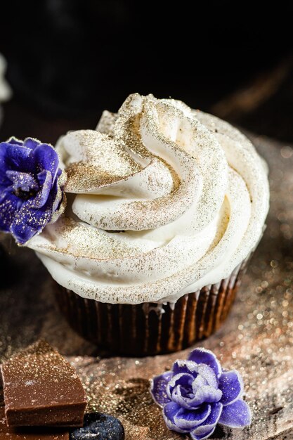 Chocolate cupcakes with blueberries on a dark table