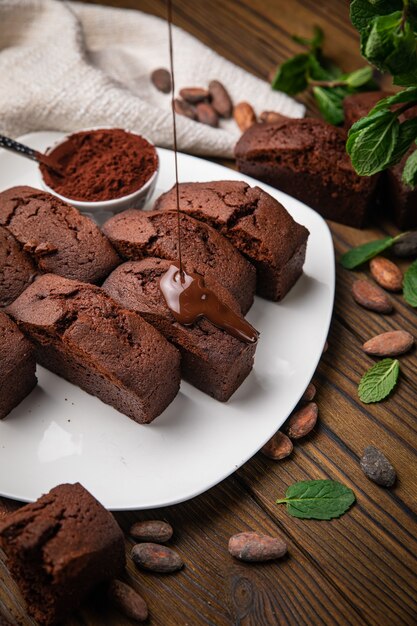 Chocolate cupcakes with mint cocoa and cocoa beans on a wooden table