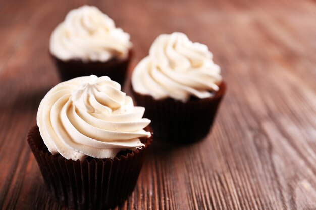 Chocolate cupcakes on wooden background