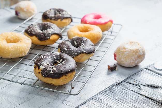 Chocolate donuts and pink donuts on the kitchen table