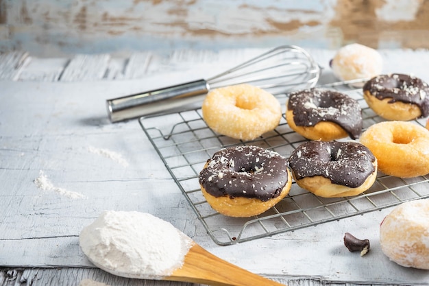 Chocolate donuts and pink donuts on the kitchen table