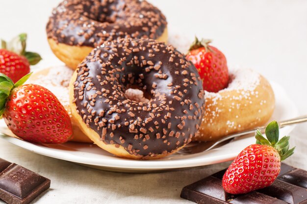 Chocolate donuts with fresh strawberries