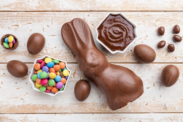 Chocolate Easter bunny eggs and sweets on rustic background