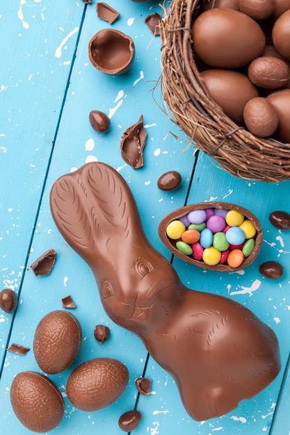 Chocolate Easter bunny eggs and sweets on rustic background
