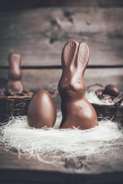 Chocolate Easter bunny and eggs on wooden backround