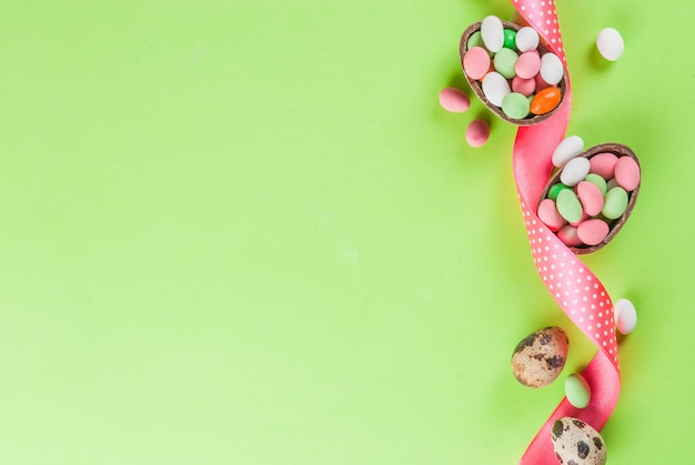 chocolate easter egg, candy eggs, quail eggs and festive ribbon