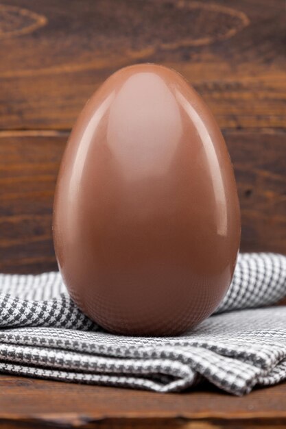 Chocolate Easter holiday egg on rustic backround