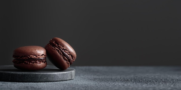 Chocolate eco handmade natural macaroons on dark background in the darkmood style