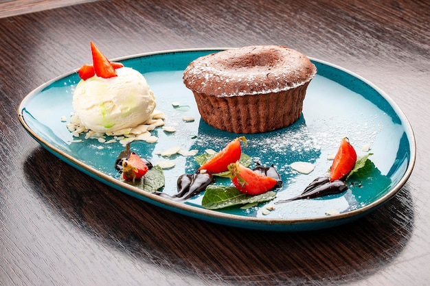 Chocolate fondant with ice cream balls On a wooden background