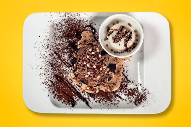 Chocolate fondant with vanilla ice cream on a yellow background