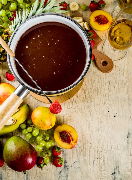 Chocolate fondue with fruit and berry