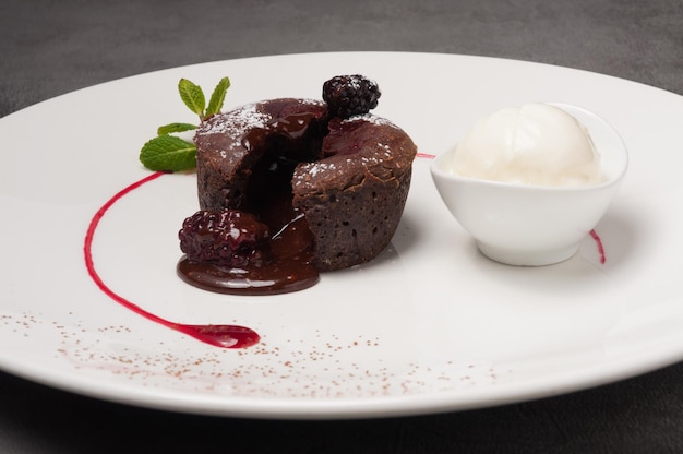 Chocolate fountain with blackberries ice cream decorated with mint