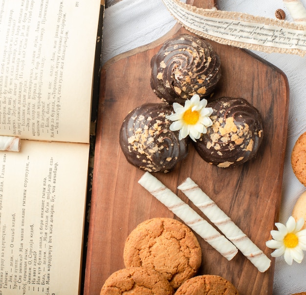 Chocolate ganache biscuits on wooden board