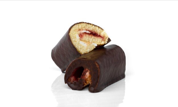 Chocolate glazed cake roll with berry jam isolated on white background.