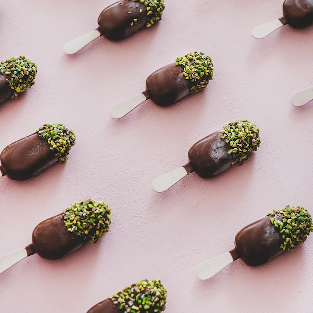 Chocolate glazed icecream pops with pistachio icing square crop