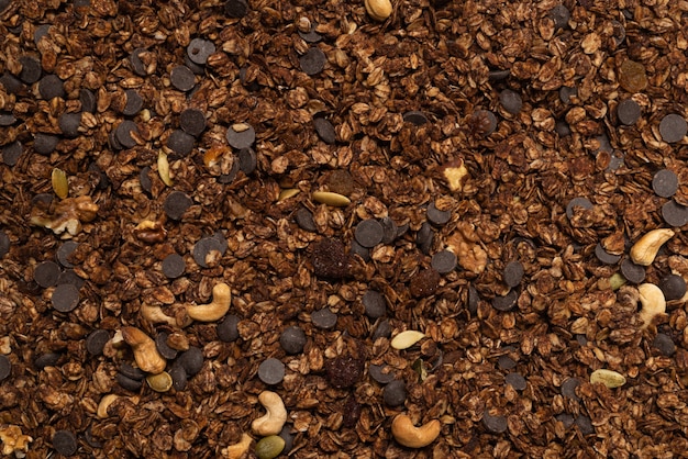 Chocolate granola cereal with nuts background