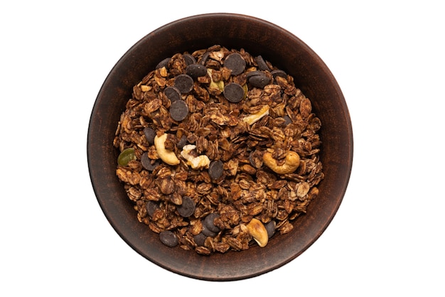 Chocolate granola cereal with nuts in a bowl surface