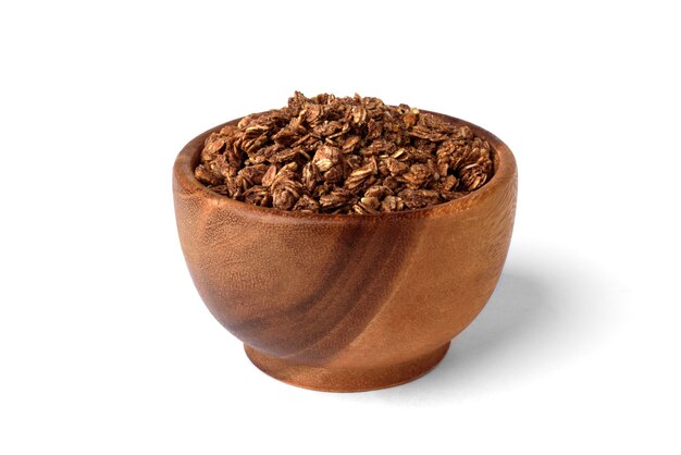 Chocolate granola in wooden bowl isolated on white background.