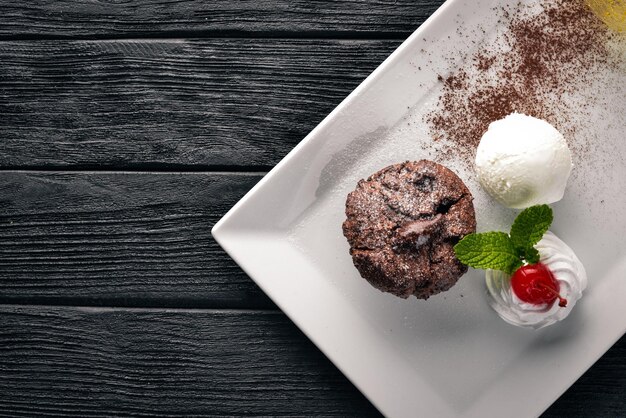 Chocolate ice cream cake on a wooden background free space for\
your text top view