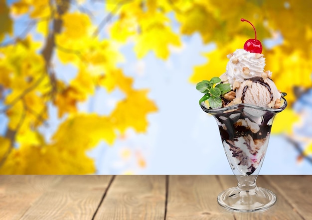 Chocolate ice cream in glass on wooden table