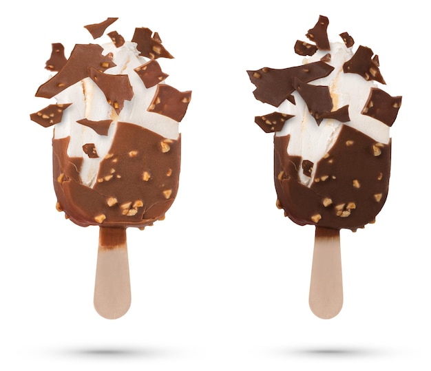 Chocolate ice cream isolate on a stick flying pieces of chocolate icing Chocolate ice cream on a white isolated background with scattered pieces of chocolate and vanilla inside