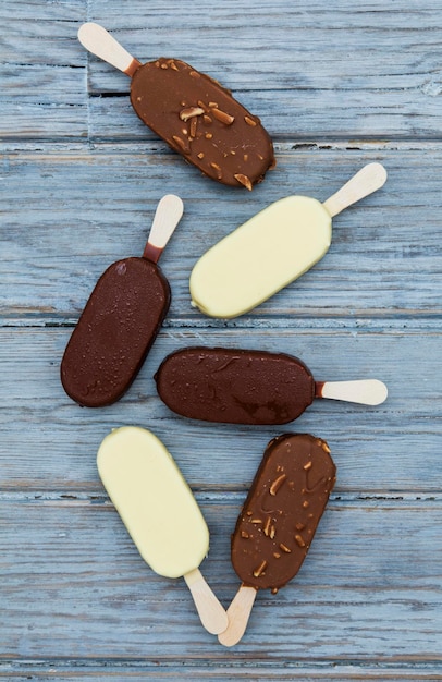 Chocolate ice cream lollies on a wooden background