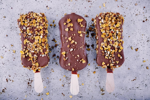 Chocolate ice cream popsicle on rustic background