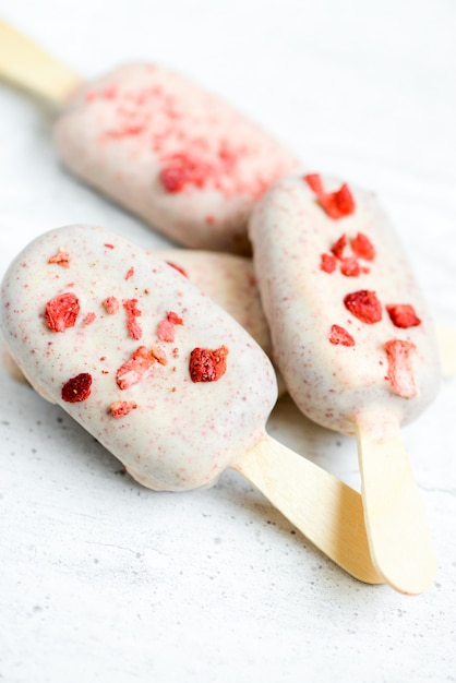 chocolate ice cream on sticks with red sprinkles