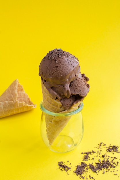 Chocolate ice cream in a waffle cone.