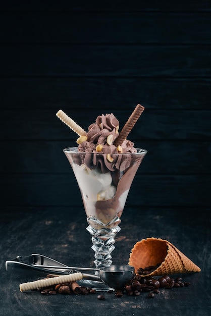 Chocolate ice cream with nuts On a black wooden background Copy space