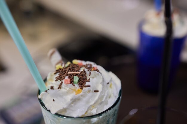 Chocolate indulgent frosting exreme milkshake with donut and sweets Crazy freakshake food trend Copy space