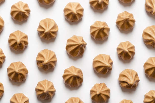 Chocolate meringue cookies on white background Top view Flat lay