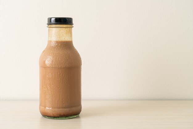 chocolate milk in glass bottle on table