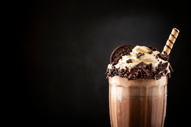 Chocolate milkshake with pieces of chocolate chip cookies