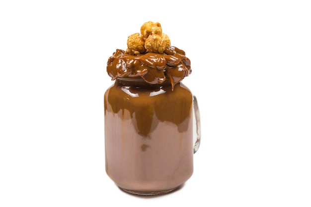 Chocolate milkshake with whipped cream, cookies, waffles, served in glass mason jar. "Freak or crazy" sweet shake. Isolated. Space for text or design.