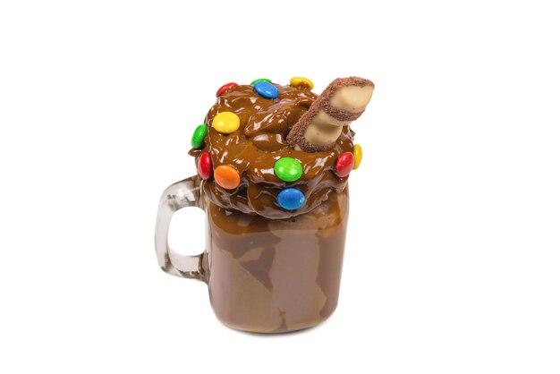 Chocolate milkshake with whipped cream, cookies, waffles, served in glass mason jar. "Freak or crazy" sweet shake. Isolated. Space for text or design.