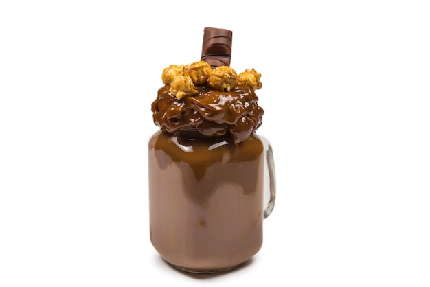 Chocolate milkshake with whipped cream, cookies, waffles, served in glass mason jar. "Freak or crazy" sweet shake. Isolated.