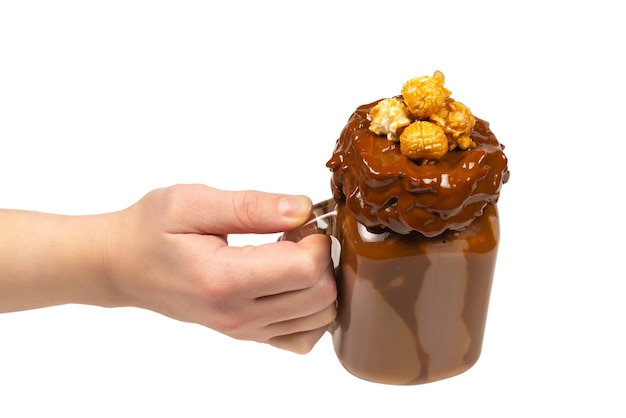 Chocolate milkshake with whipped cream cookies waffles served in glass mason jar In woman hand isolated