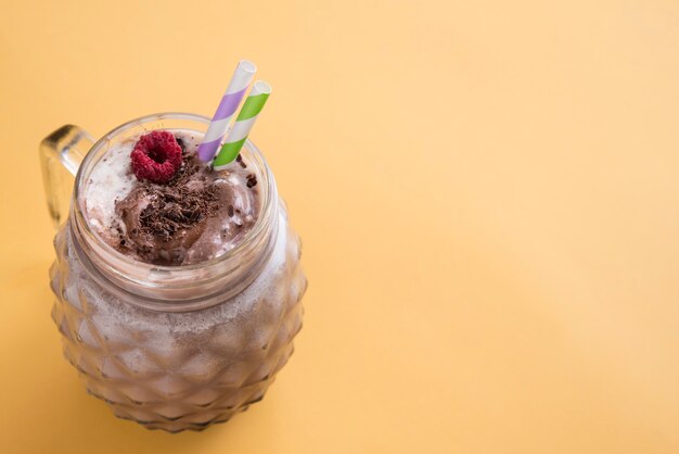 Chocolate milkshake in yellow background