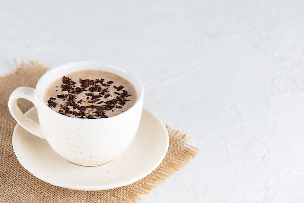 Chocolate mochaccino coffee with nuts in a mug. Horizontal orientation, copy space.