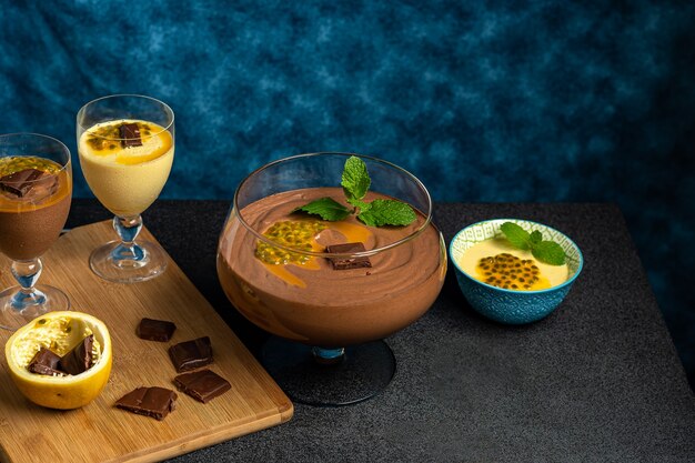 CHOCOLATE MOUSSE IN A GLASS BOWL ON A DARK TABLE