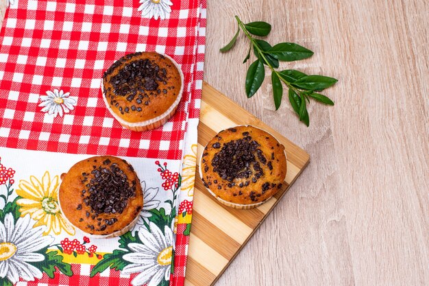 Chocolate muffin and nut muffin, homemade bakery on dark background.