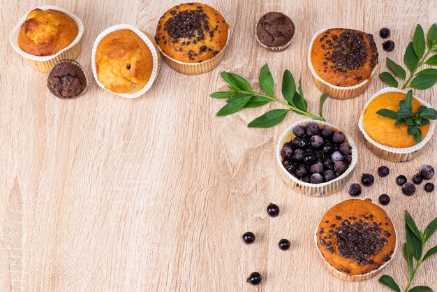 Chocolate muffin and nut muffin, homemade bakery on dark background.