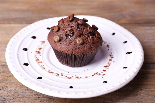 Chocolate muffin on plate wooden background