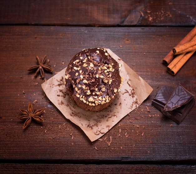 Chocolate muffin sprinkled with nuts 