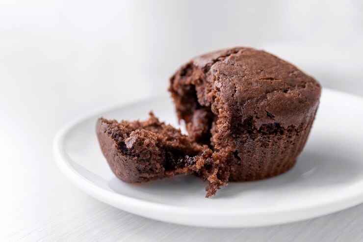 Chocolate muffin on white plate. Homemade cakes cupcakes. Close up.