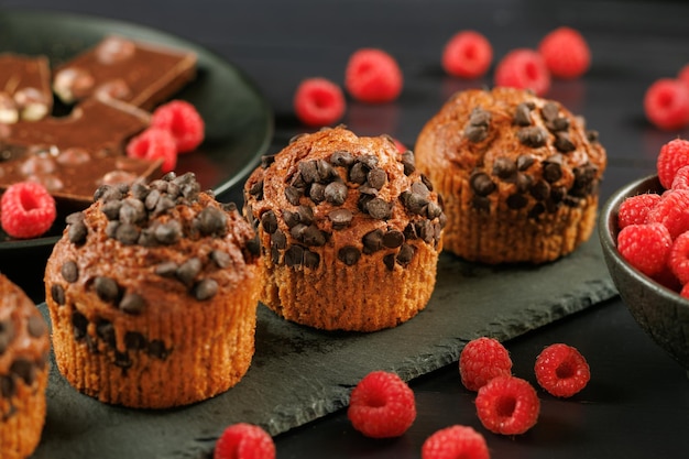 Chocolate muffin with berries Appetizing cupcakes on a dark background