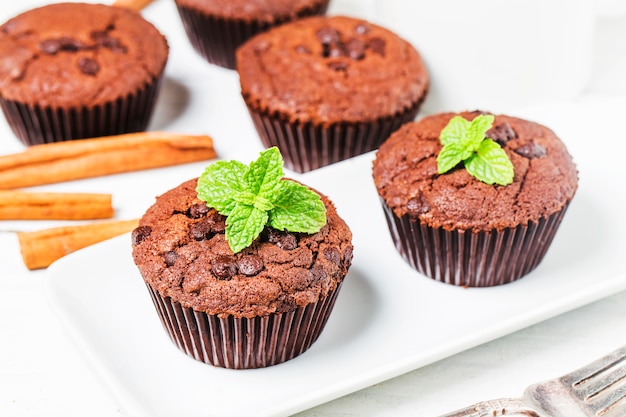 chocolate muffin with mint on a wooden table